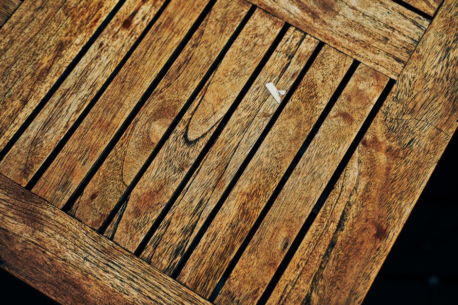Close-up of a rustic wooden table showcasing unique grain patterns from above.